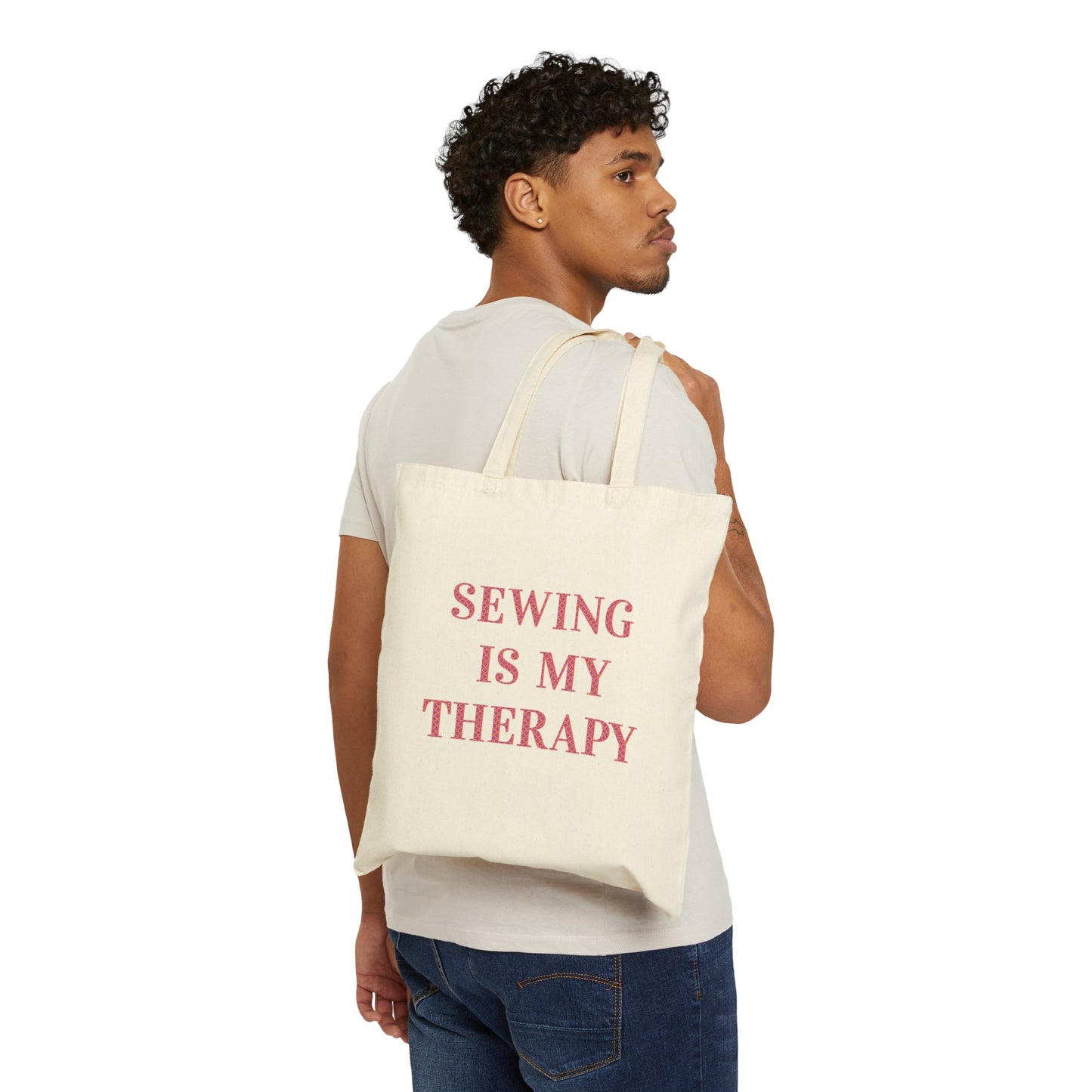 Sewing is my therapy canvas bag being held by a young person.