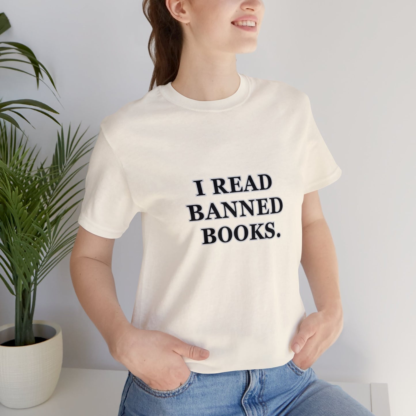 Woman wearing a cream color t-shirt which reads, I read Banned Books.