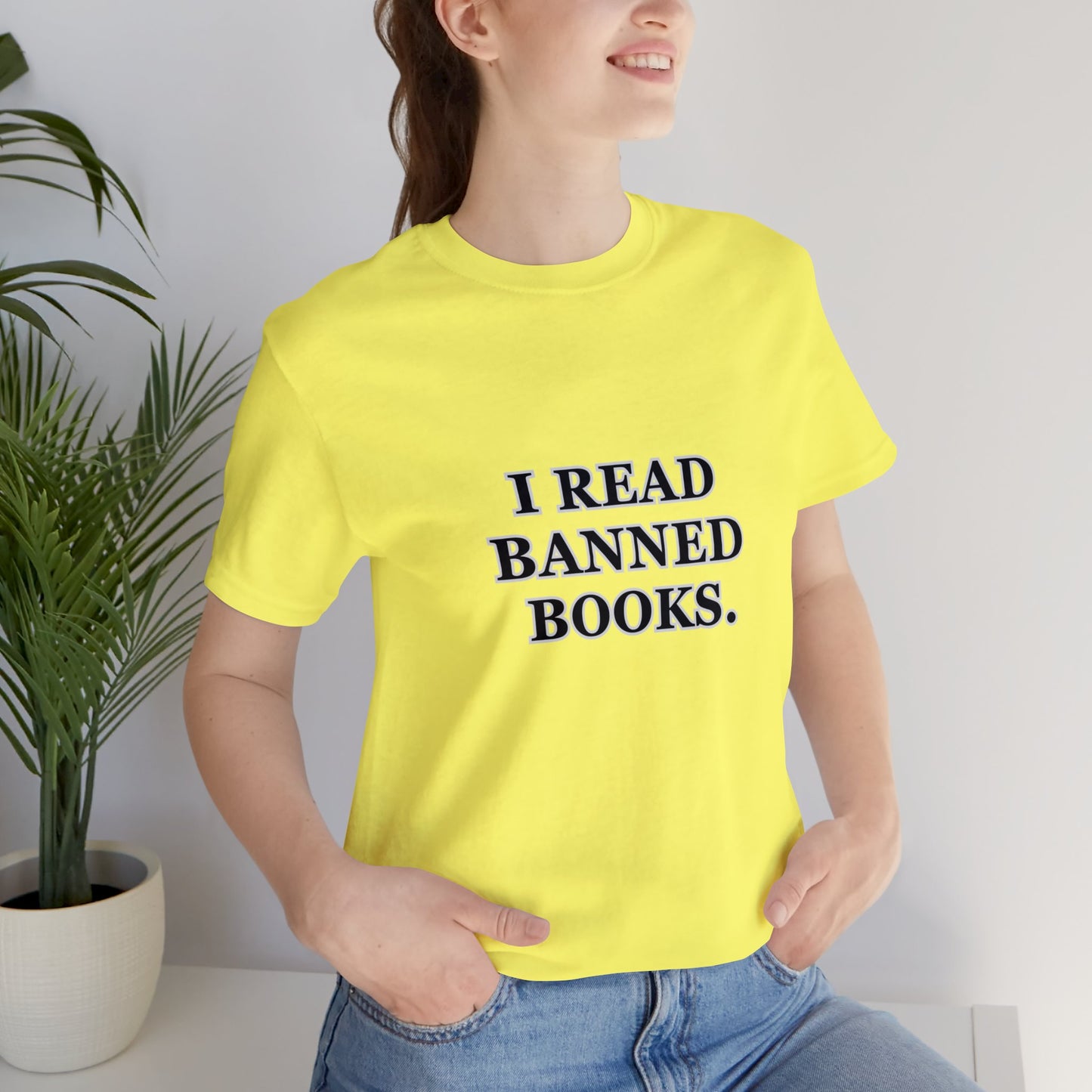 Woman wearing a yellow t-shirt which reads, I read Banned Books.