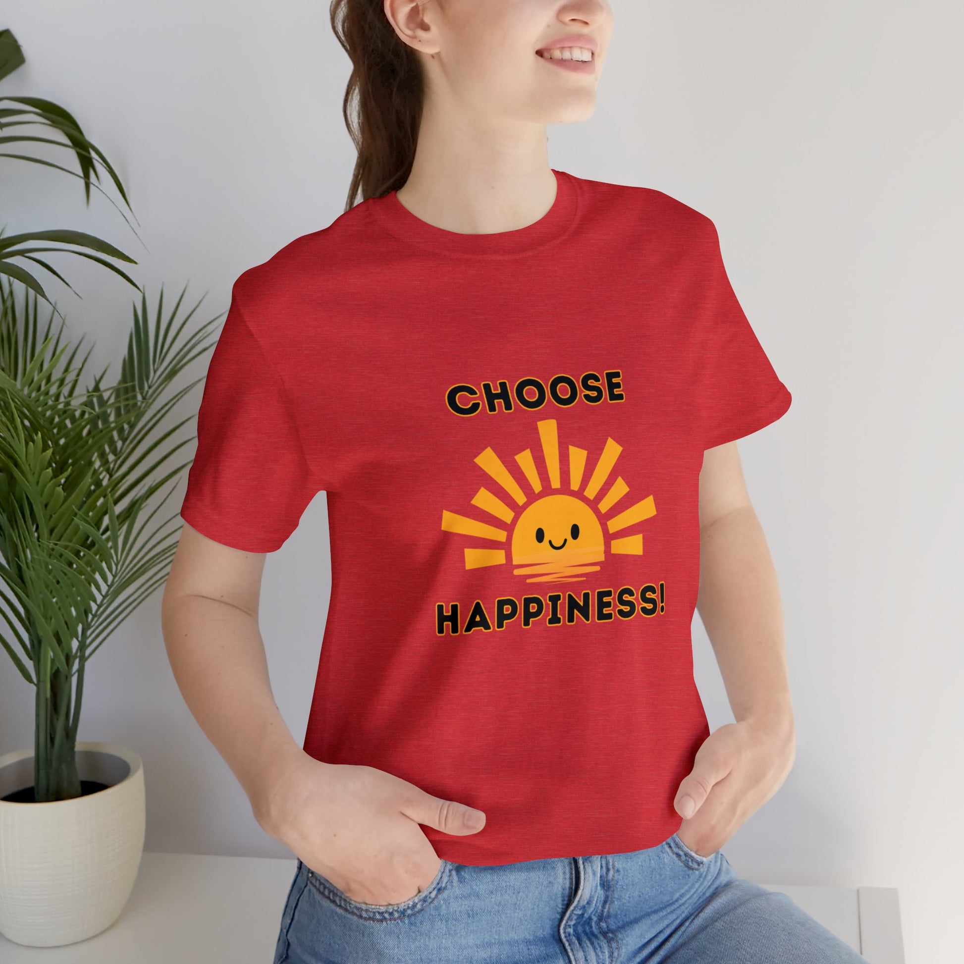 Young smiling woman wearing a red t-shirt which reads, Chose Happiness over a smiling sunshine.