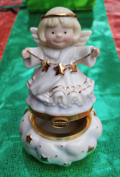 Lenox Christmas Angel figurine, ornament. Cherub faced angel gift made from china holding stars. The bottom opens and has a trinket holder in the base.