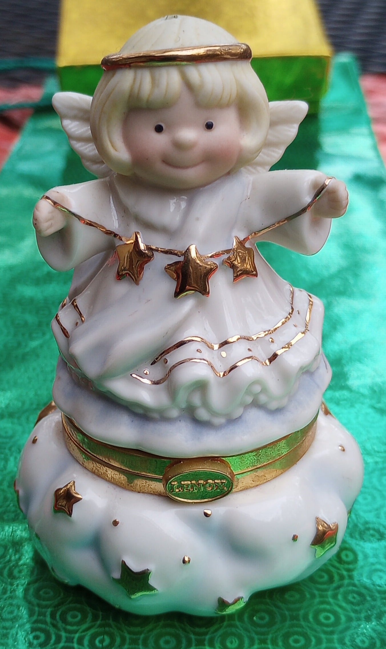 Lenox Christmas Angel figurine, ornament. Cherub faced angel gift made from china holding stars. The bottom opens and has a trinket holder in the base.
