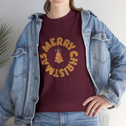 Holiday, Christmas. A woman is wearing a Christmas t-shirt with a wreath made out of gingerbread cookies and spells out Merry Christmas. A Christmas tree cookie dangles in the middle of the wreath.