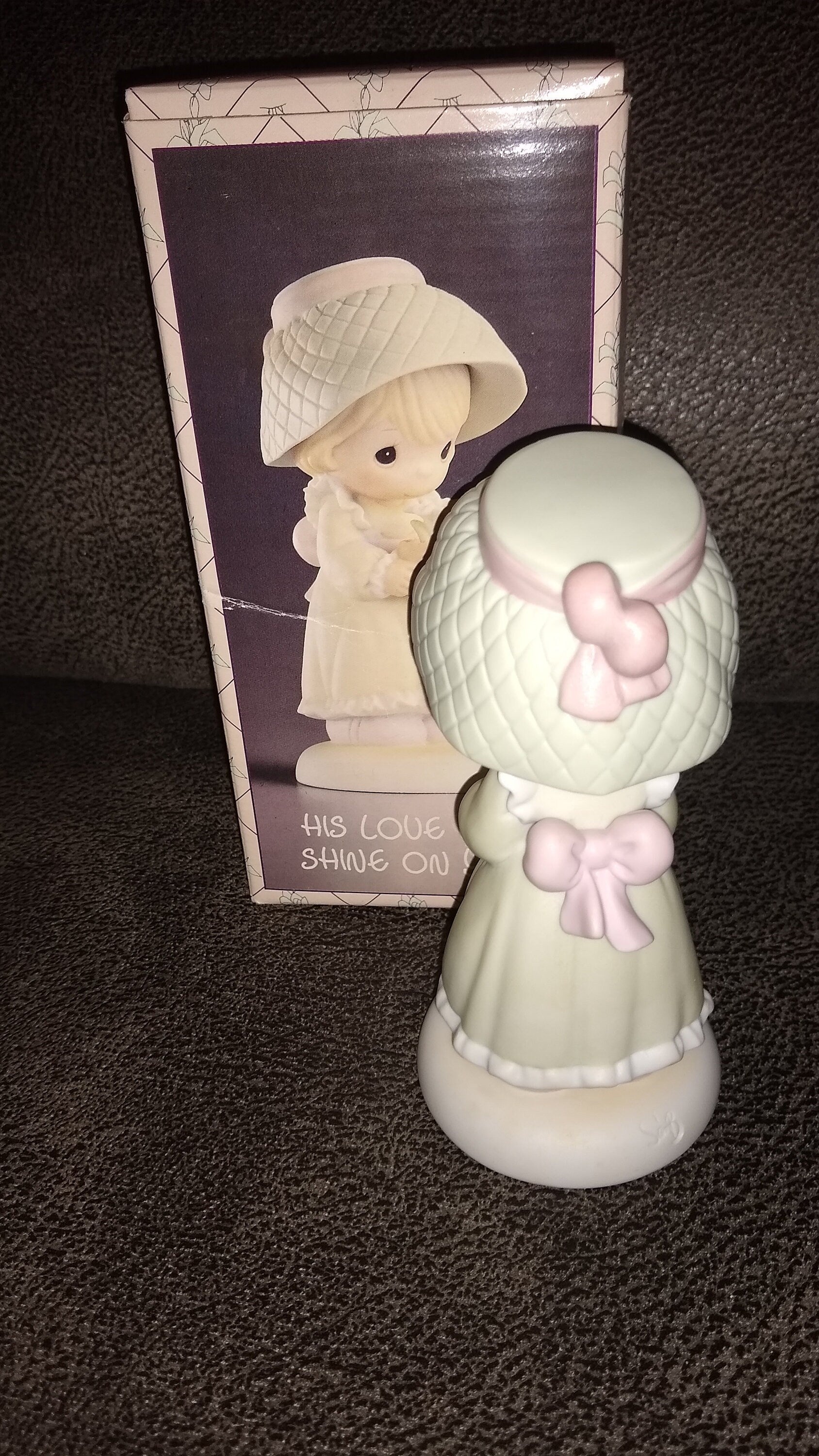 Precious Moments Figurine By Enesco.  His Love Will Shine On You Figurine Featuring A Woman Holding A Flower Pot With Flowers.