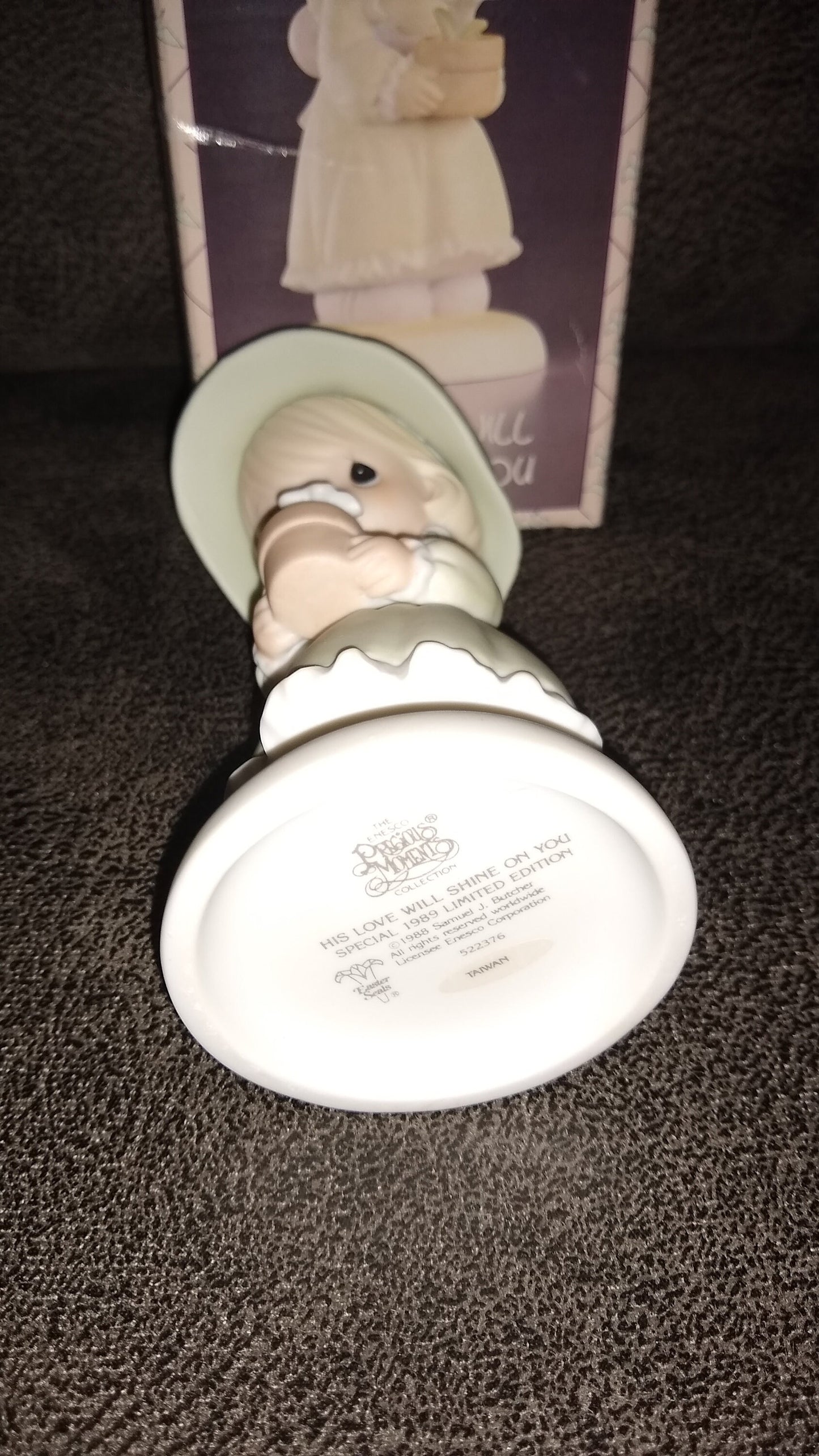 Precious Moments Figurine By Enesco.  His Love Will Shine On You Figurine Featuring A Woman Holding A Flower Pot With Flowers.