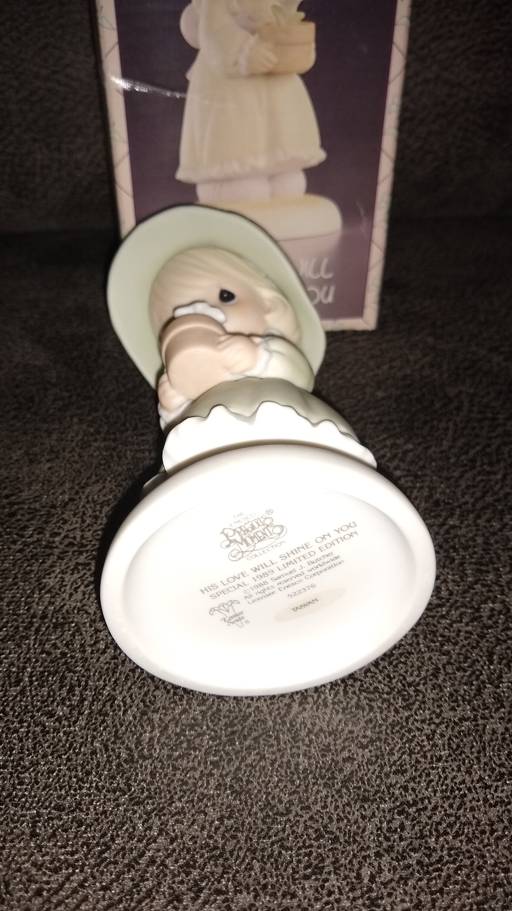 Precious Moments Figurine By Enesco.  His Love Will Shine On You Figurine Featuring A Woman Holding A Flower Pot With Flowers.